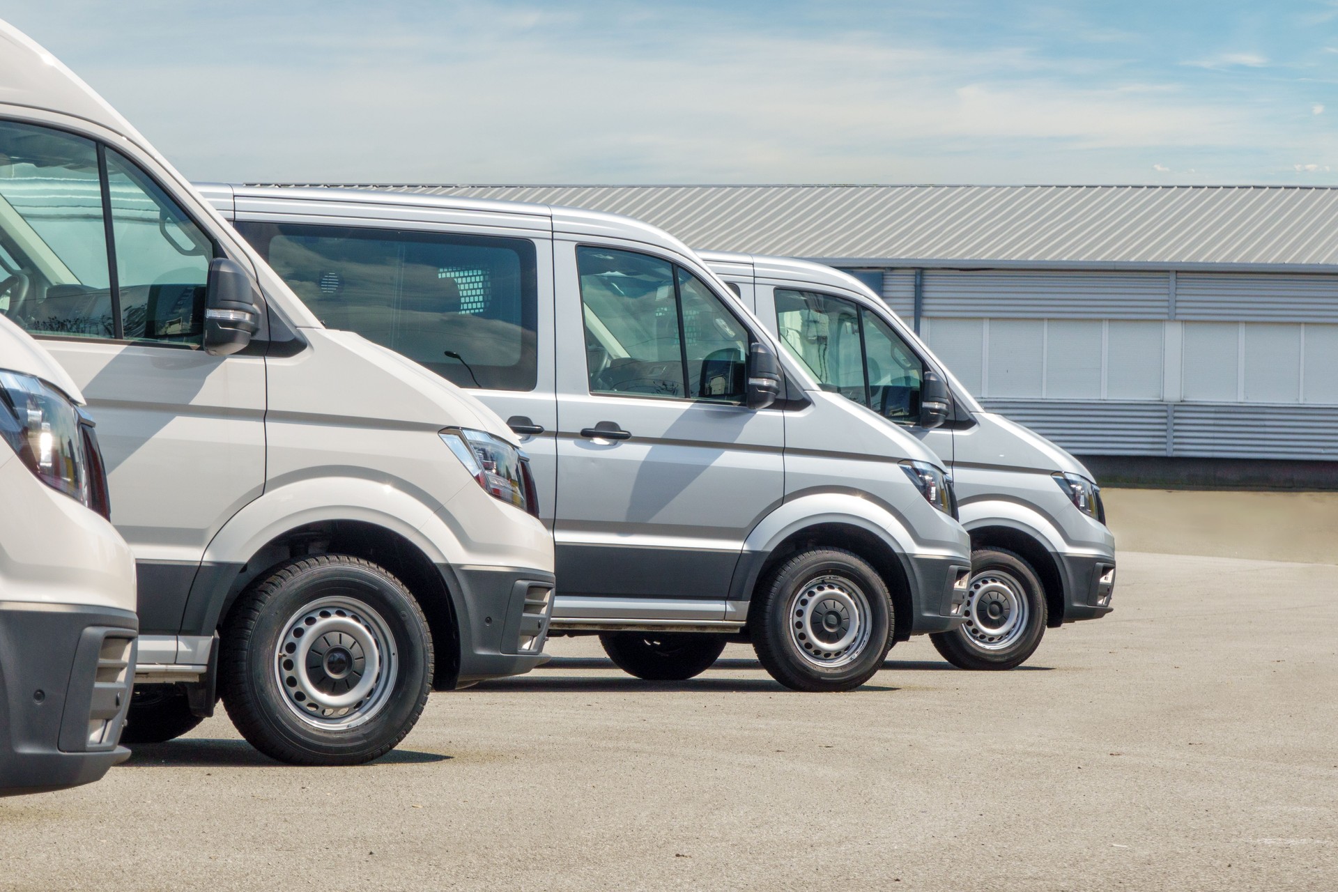 Minibuses and vans lined up in front of the distribution center